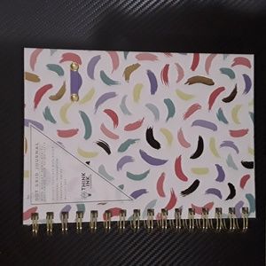Dot grid personal journal with watercolor swirls and place for a pen